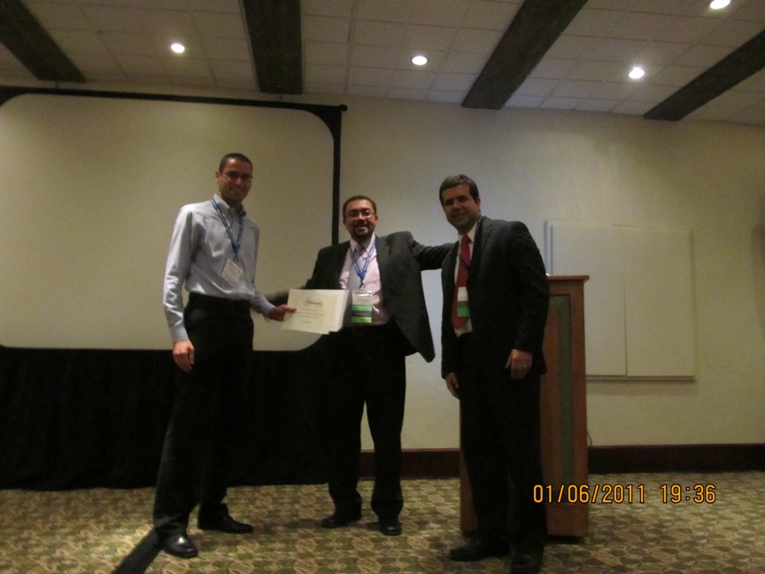 Matteo Senesi receiving the 1st Place, Phononics 2011 NSF Best Student Poster Presentation Award from the conference chairs